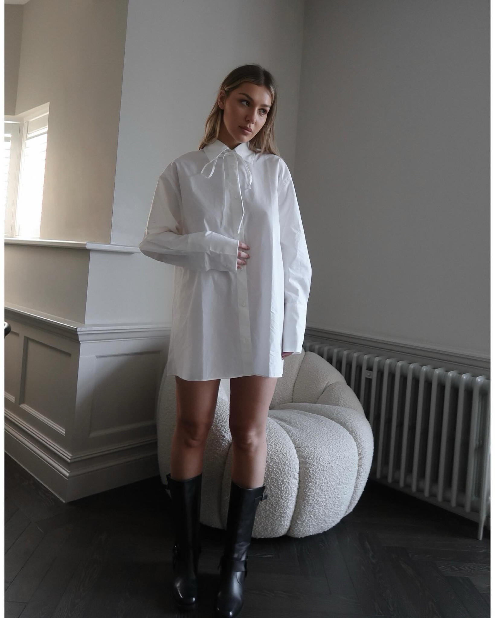 Oversized white boyfriend shirt with a bow and knee high boots from Alohas. I’m wearing size 10 in a shirt 

#LTKMostLoved #LTKeurope #LTKstyletip