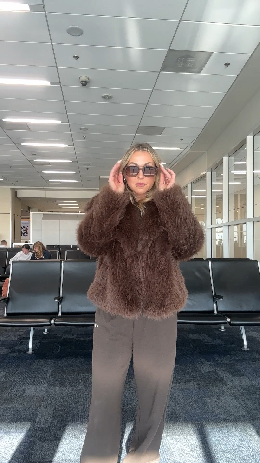 NYC at Christmas calls for elevated comfort 🤎
This chocolate faux fur coat from Amazon instantly dresses up an easy Alo set—perfect for travel days, city walking, and cozy holiday plans. Finished with classic UGGs and oversized Amazon sunglasses for that effortless airport-to-NYC vibe. Warm, chic, and comfortable without sacrificing style.

If you’re looking for a NYC winter outfit, Christmas travel style, or an over 40 elevated travel look, this one checks every box.

Everything is linked!

#LTKFindsUnder50 #LTKOver40 #LTKTravel