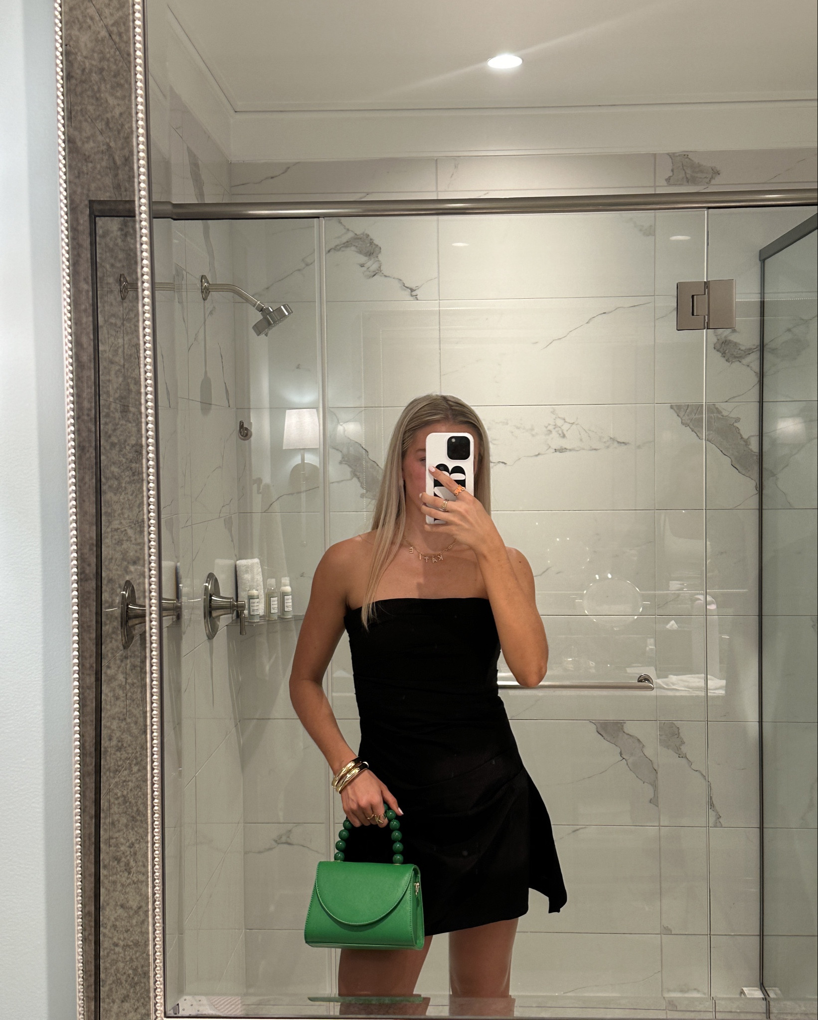 Black strapless mini dress styled with green purse and gold accessories! Night out outfit 

#LTKstyletip #LTKitbag #LTKfindsunder100