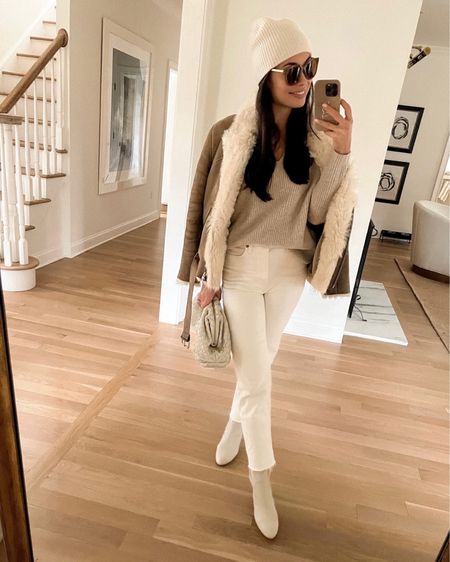 Kat Jamieson of With Love From Kat wears a winter outfit. Iro jacket sold out, similar linked below! Shearling jacket, cashmere sweater, cream denim, leather booties, pouch clutch, white beanie, classic style, neutral style. 

#LTKitbag #LTKSeasonal #LTKstyletip