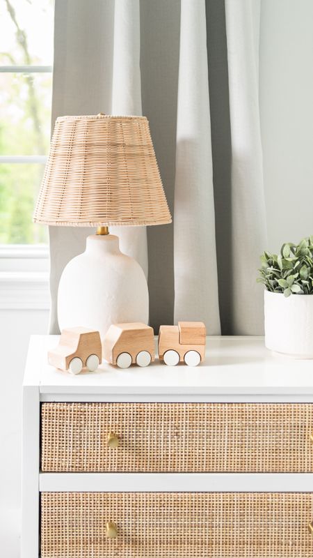 Neutral baby nursery with white and wicker furniture, wicker and white lamp, wooden vehicle toy, coastal style home decor

#LTKHome #LTKBaby #LTKFamily