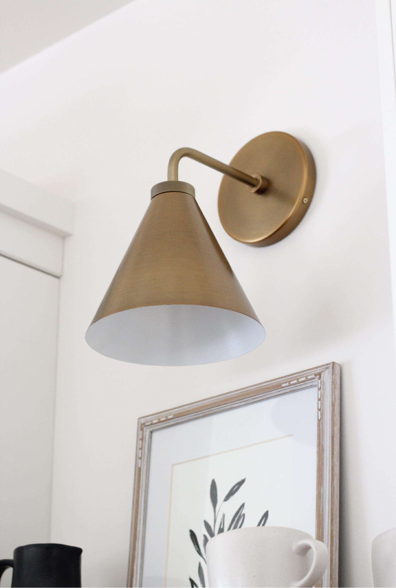This tumbled brass sconce added character and warmth to our kitchen. Love how it looks above the open wood shelves both day and night. Beautiful finish!

#LTKHome