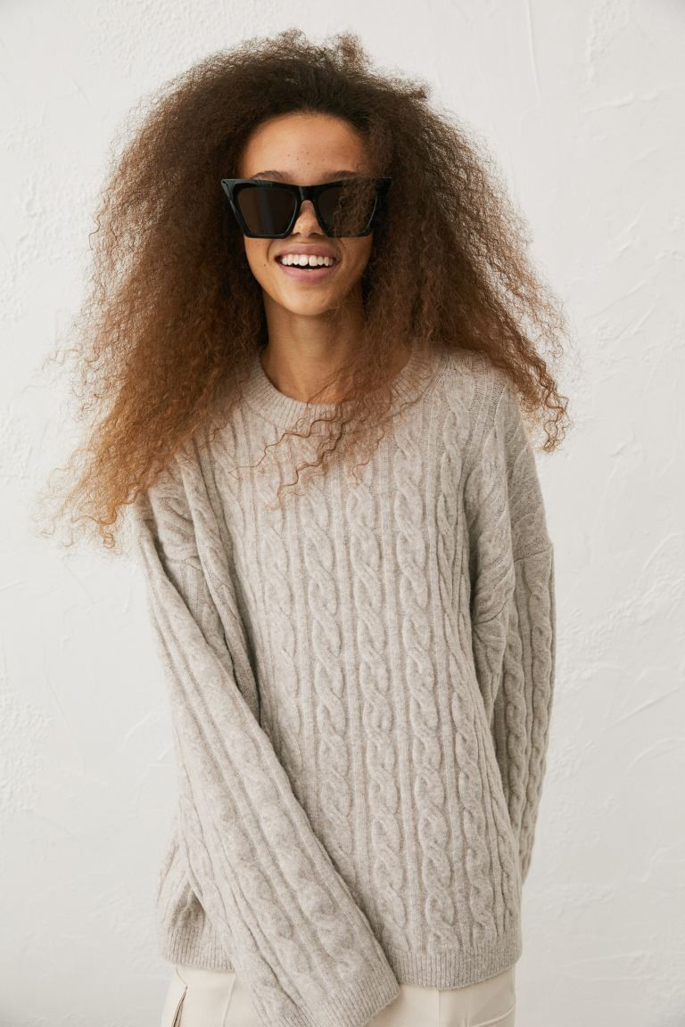 Soft, cable-knit sweater with wool content. Dropped shoulders, long sleeves, and ribbing at neckl... | H&M (US + CA)