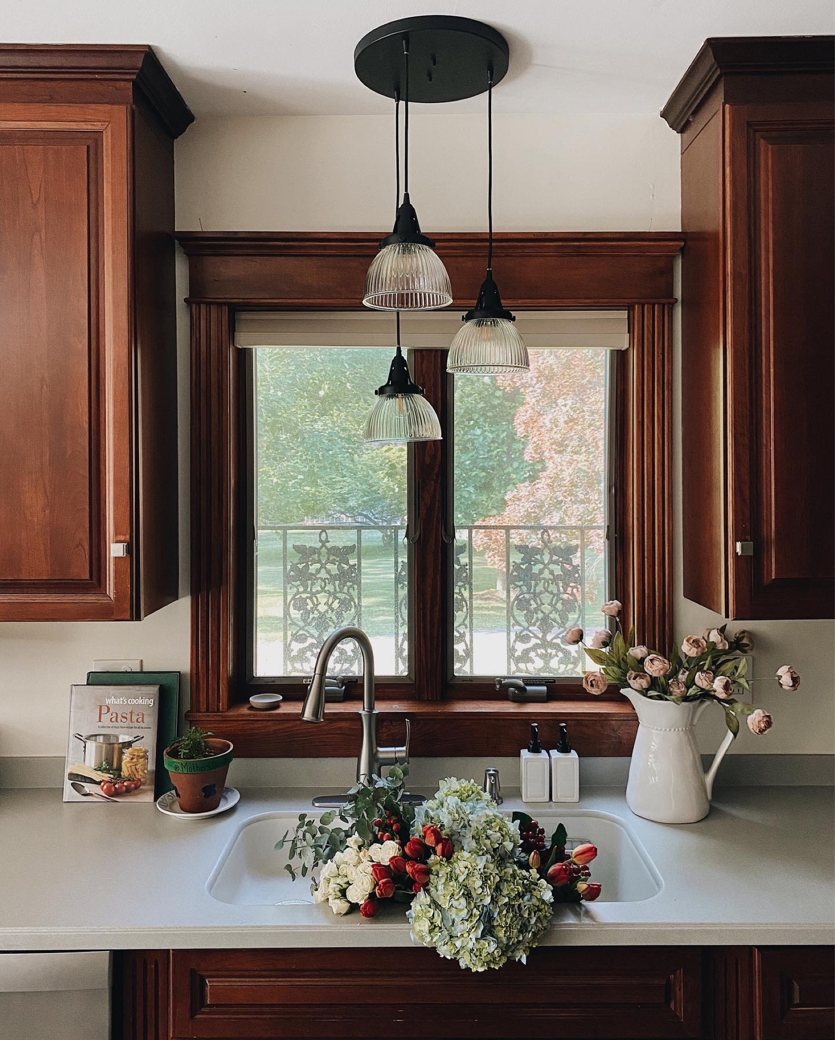 New kitchen lighting by Hunter Fan Co!We LOVE our Hunter Fan Co master bedroom fan and now our kitchen pendant lighting. These lights have a beautiful fluted glass & matte finish in three different colors. The black brings a modern look to our traditional cherry wood kitchen.

#LTKFind #LTKxNSale #LTKhome