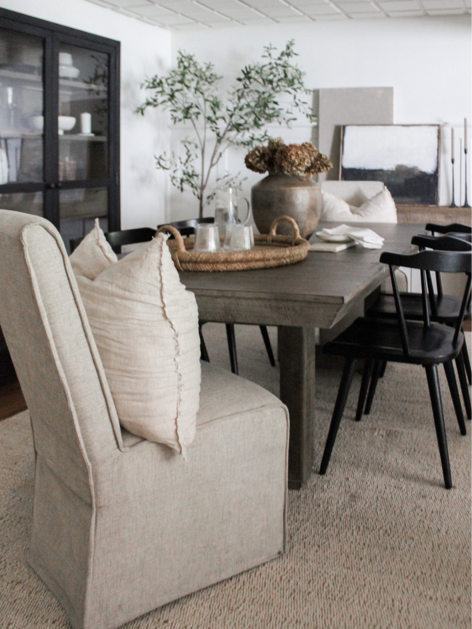 fall table centerpiece - dried hydrangeas in an oversized beautiful vessel. easy & such a statement 

Ribbed glassware. Fluted glassware. Home decor. Dining room. Fall dining room. Fall tablescape. Thanksgiving table. Thanksgiving tablescape. Olive tree. Black cabinet. Curio cabinet. Dining room table. Black modern dining chairs. Dining room chairs  

#LTKSeasonal #LTKHoliday #LTKhome