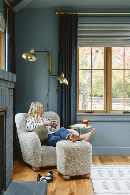 That warm taupe shearling chair against the dark blue, with the brass and our pretty rug popping in – it’s just so balanced and cozy. This is probably the best representation of the paint color – it has a lot of depth to it. Also, look closely and you might see an alpaca in the backyard:)

#LTKhome #LTKSeasonal #LTKstyletip