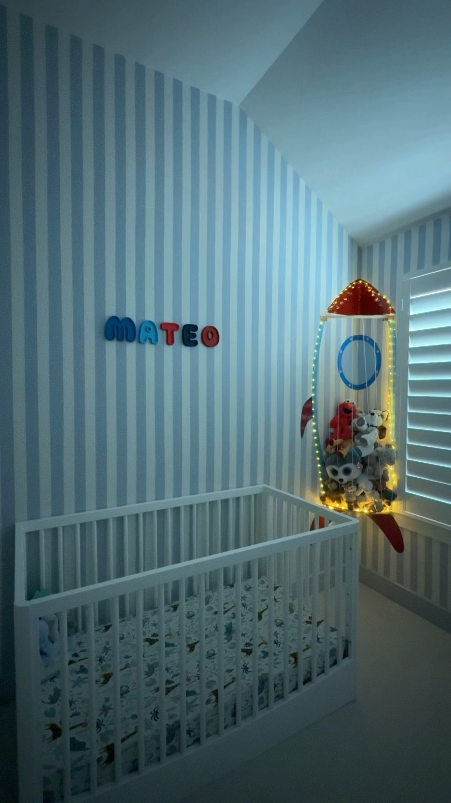 Whimsical Little Boys Room Inspo. Painted Stripes are Sherwin Williams Upward Blue. Mateo letters are from an Etsy Shop (linked exact) Rocket Ship Stuffed Animal holder is from Amazon (linked exact) Storytime Wire Sign and Bookshelves are from Amazon (linked exact) the blue has been sold out since my original post so I also linked other sellers that you can make custom wire signs from and ask them to do it the same way if you'd like. The gallery wall is all stuff from Amazon and Target I accumulated and just used trial and error until it looked good. I linked everything I could there as well.  

 #LTKmomlife #LTKHome #LTKKids