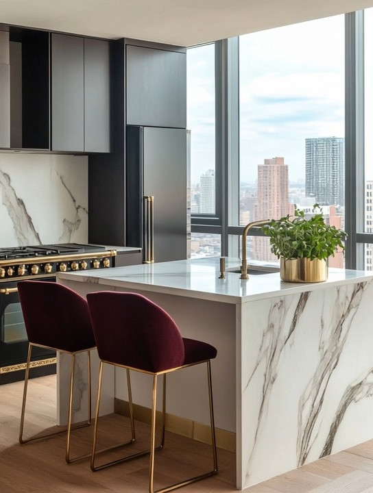 Black and gold kitchen design at its finest. This sunlit kitchen island brings together black and gold appliances, a sleek stove and fridge, elegant velvet high chairs, and a crisp marble island for a look that feels both ultra-glamorous and effortlessly minimal. During the day, natural light highlights the clean lines and rich finishes; at night, the space transforms into a warm, sophisticated gathering spot.

Small details make all the difference here. A gold herb planter on the island adds a touch of glamour while also bringing nourishment and life into the kitchen. This balance of luxury and function creates a kitchen that feels elevated yet livable—modern, elegant, and timeless. It’s proof that minimalist kitchens don’t have to feel cold; with the right materials and accents, they can feel rich, inviting, and beautifully intentional. 

 #LTKHome