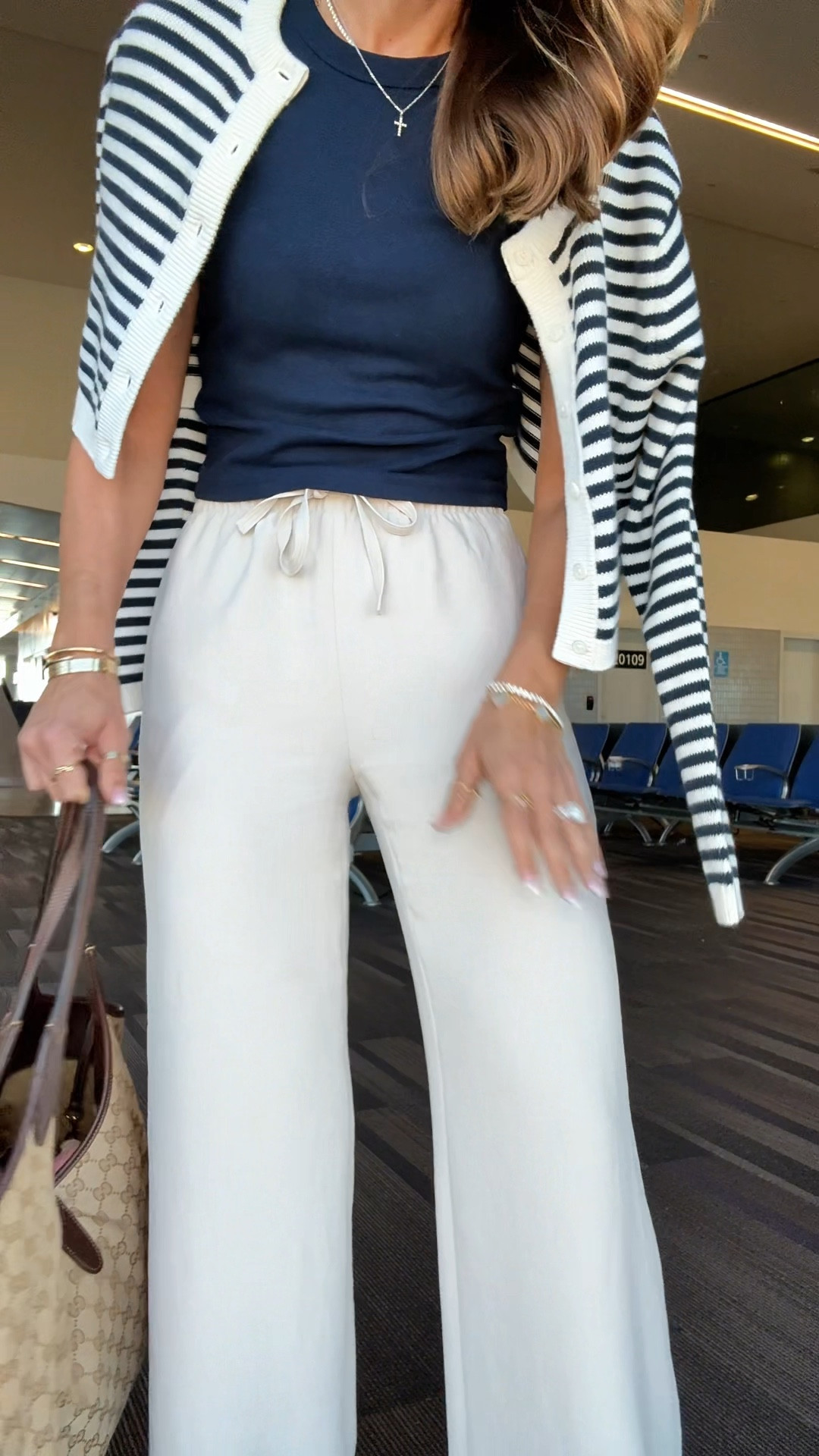 My travel outfit of the day! Aritzia The Lodge Pant - Crepette. Size XS regular, color ‘Metropolis Taupe’. Comes in short and tall, too. Wrinkle resistant with an elastic waist and high-rise. Aritzia t-shirt in XS. Aritzia striped cropped cardigan in 2XS. Jelly ballet flats are whole sizes only. I’m a 6.5 and sized down to a 6 per reviews. Business casual. Elevated casual. Workwear. Coastal outfit. 

#LTKPetite #LTKootd #LTKTravel