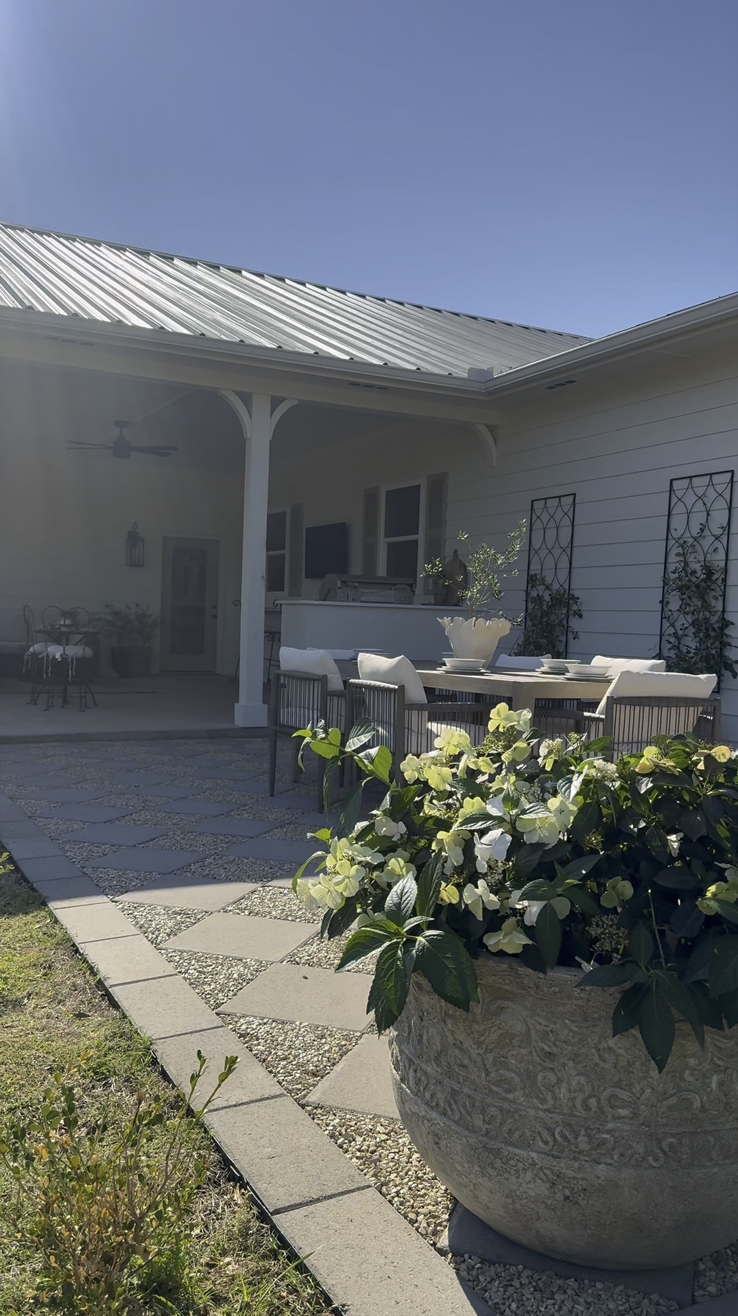 The backyard at the flip house got some new patio furniture! I love how this paver patio dining space turned out! These planters are HUGE and also heavy but not too heavy to move which is great. A couple people and you can move them around but heavy enough to stay standing in the wind!! A splurge but they are great quality! Outdoor kitchen. Backyard. Covered patio  

#LTKHome #LTKSeasonal