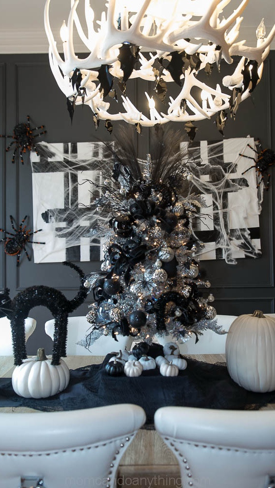 Comment “Links” for links to everything I used to create this Halloween tablescape.  You’ll find everything linked up to my LTK page.

This was such a fun look to create with the silver tinsel Christmas tree, the black cats, the cobwebs, giant spiders, and bats hanging from my chandelier.  So spooky!

Follow me for more decor inspirations.

Happy Halloween!

Tara

#Halloween #happyhalloween #trickortreat #pumpkins #fall #halloweentree #halloweendecor #halloweendecorations #blackcats #spiders #bats #spiderwebs #seasonaldecorating #seasonaldecor #blackandwhite #blackandwhitedecor #tablescape #diningroom #tinselChristmastree #Christmastree #Halloweentree