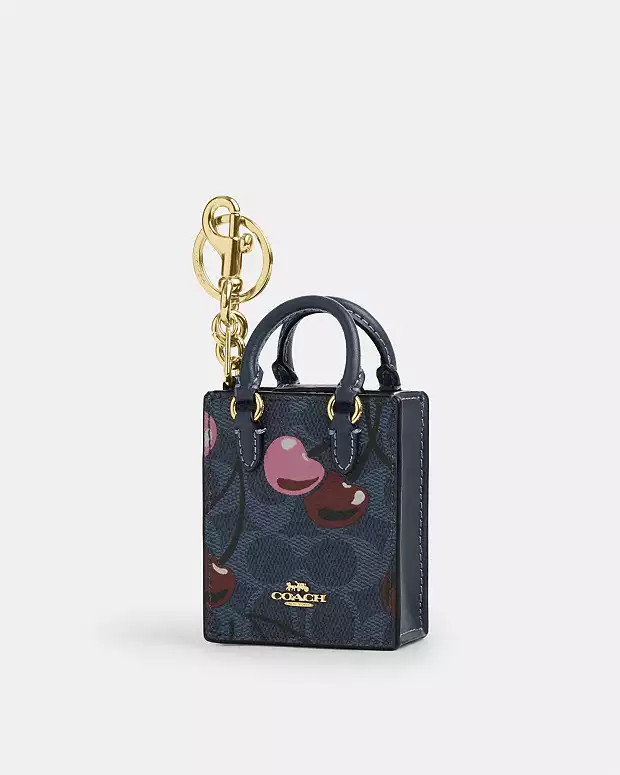 North/South Mini Tote Bag Charm In Signature Canvas With Cherry Print | Coach Outlet US
