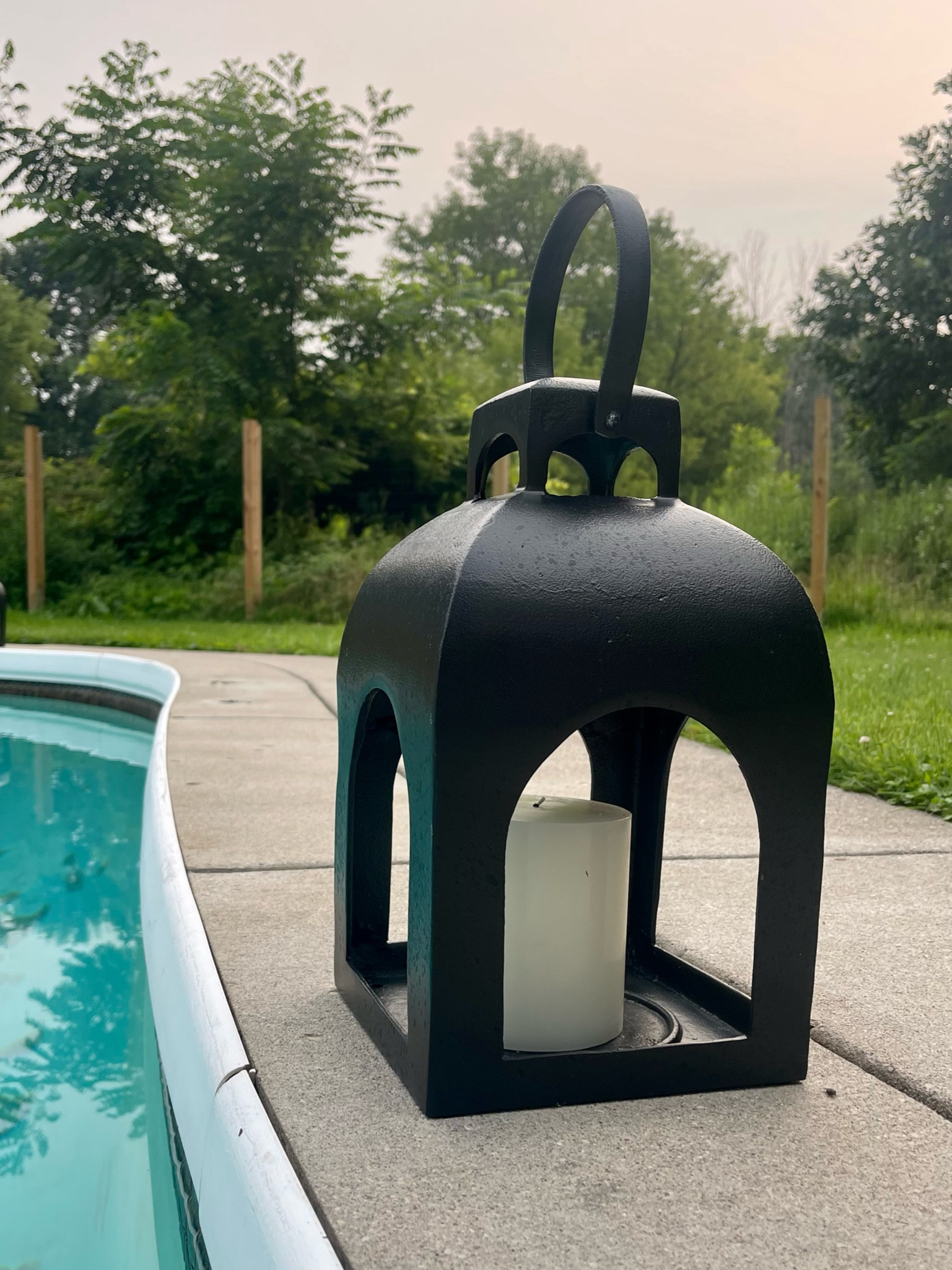 Poolside black lanterns with candles to set the mood

#LTKFind #LTKhome #LTKfamily