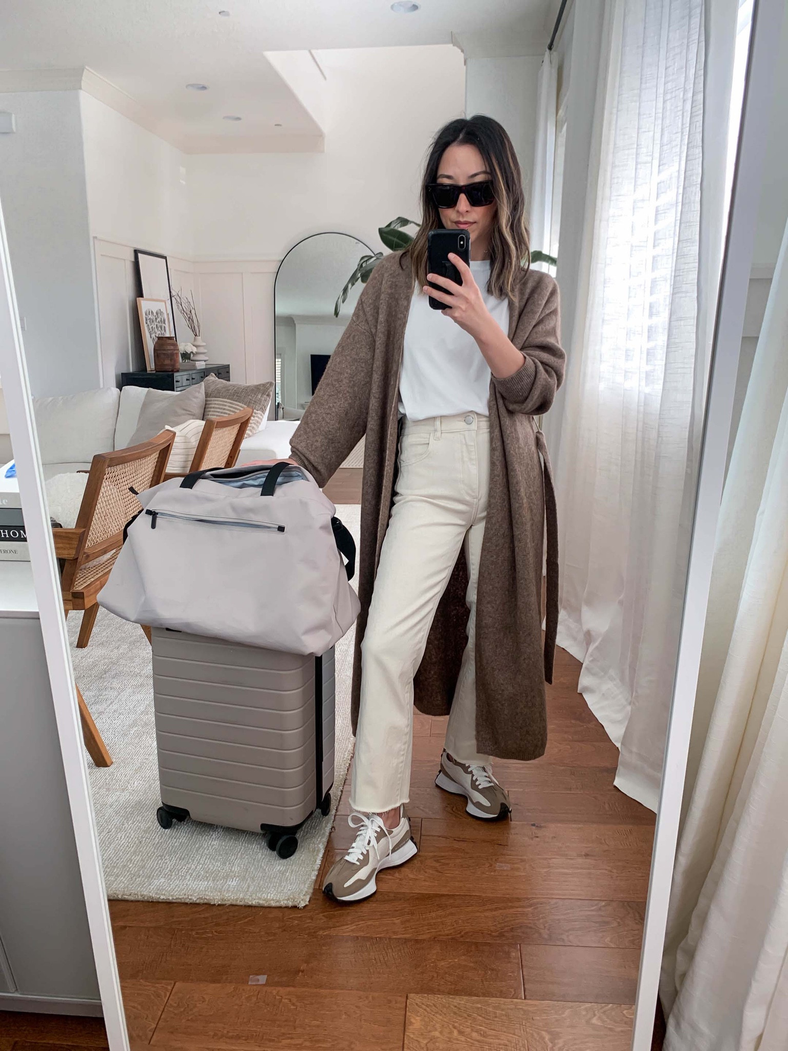Travel airport style. Airport travel outfit ideas. Comfy travel outfits. 

Cardigan - NEIWAI small. Runs big. 
Tee - Everlane medium
Jeans - DL1961 25
Sneakers - New Balance 4.5 men’s. 
Bag - Everlane 
Carry on - Away
Sunglasses - Celine