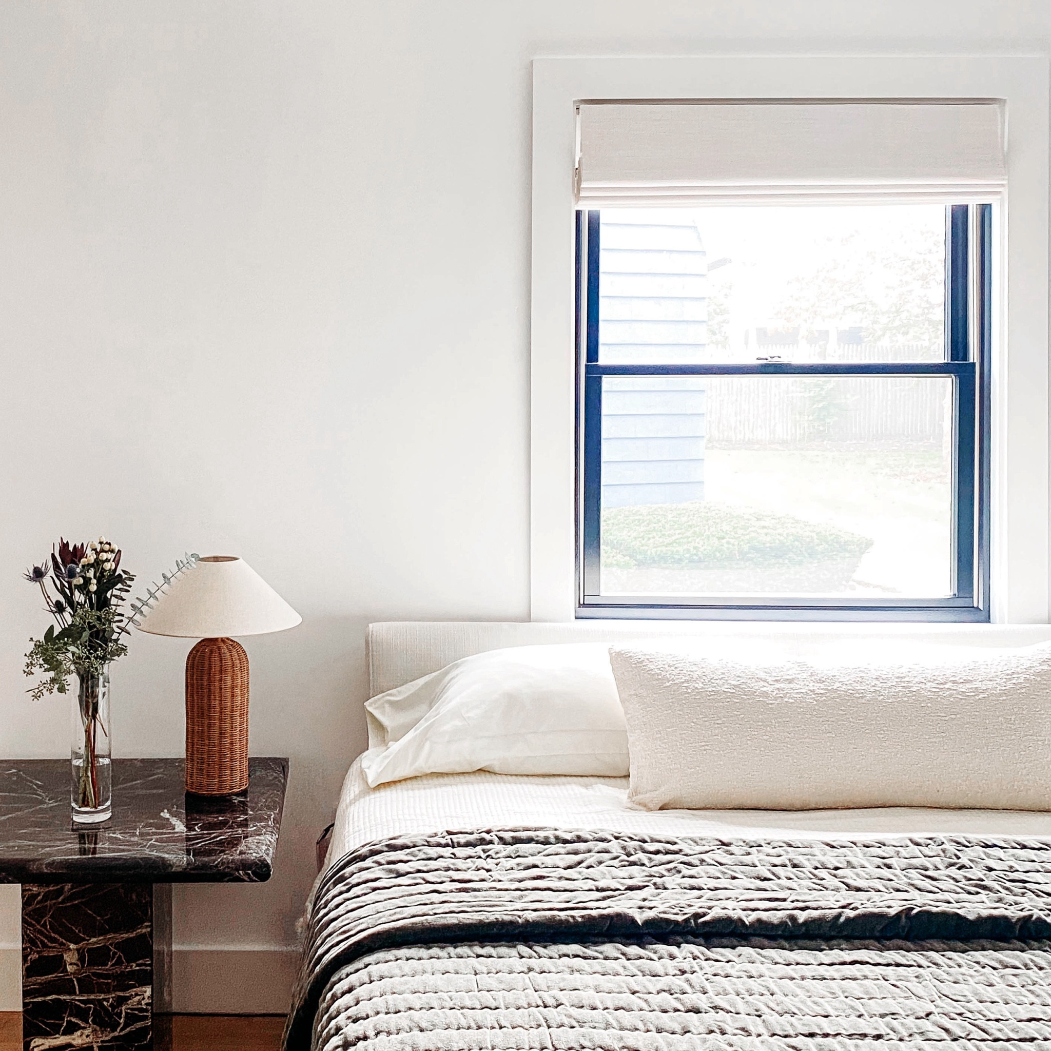 with its minimalist design and neutral color palette, this #dwelloctoberstudio bedroom is the perfect refuge from the chaos of everyday life. changes to this room were mostly cosmetic: we swapped out the busy floral wallpaper for clean white paint, whitewashed the original hardwood floors, and introduced texture through the vintage stone table, boucle throw pillow, and rattan lamp. this primary bedroom design is all about understated simplicity! #dwelloctoberrealestate #dwelloctober

#LTKhome