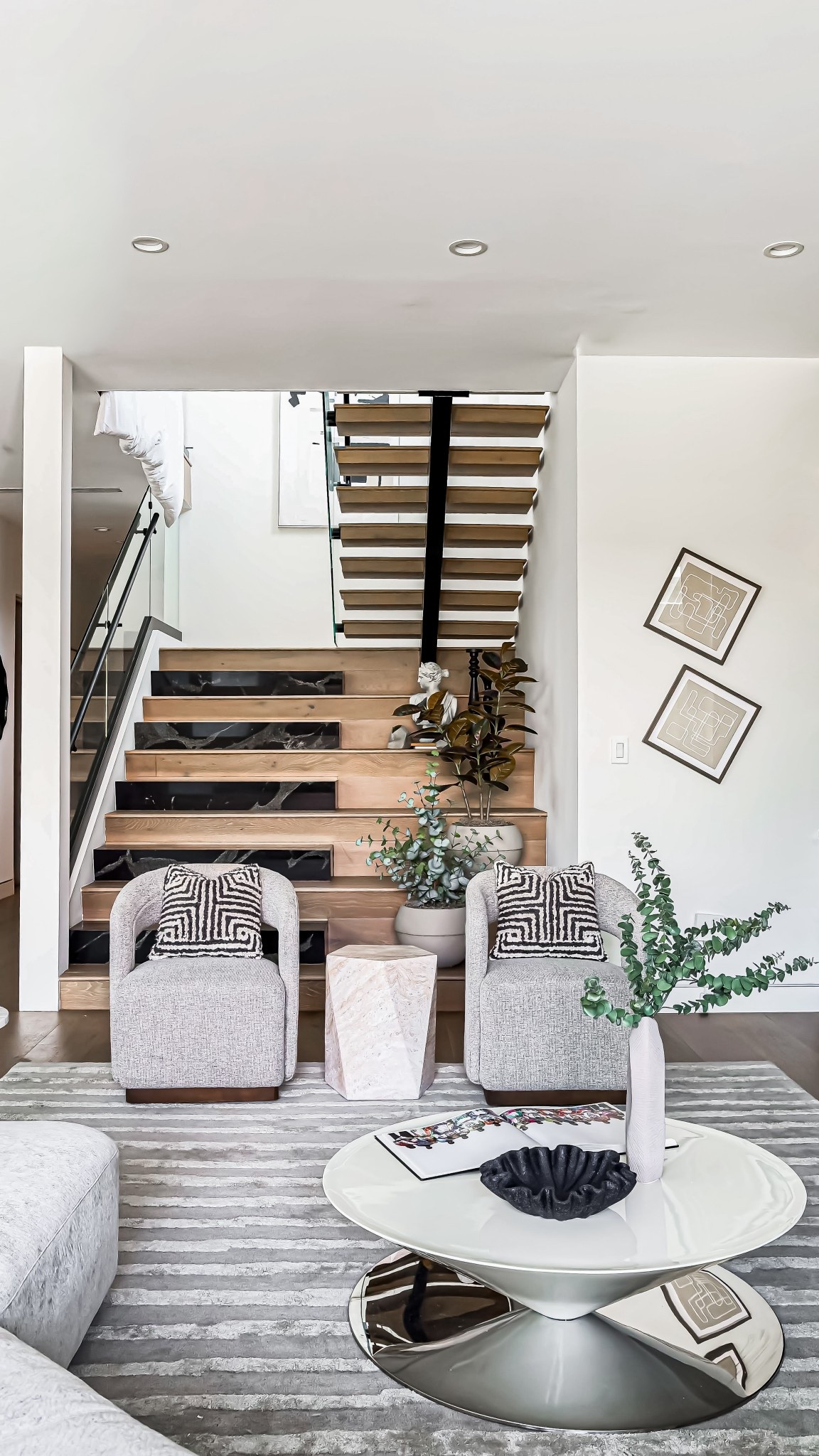 Modern elegance meets natural warmth. Loving the mix of light wood, black marble, and cozy textures in this stairway nook.

#LTKHome