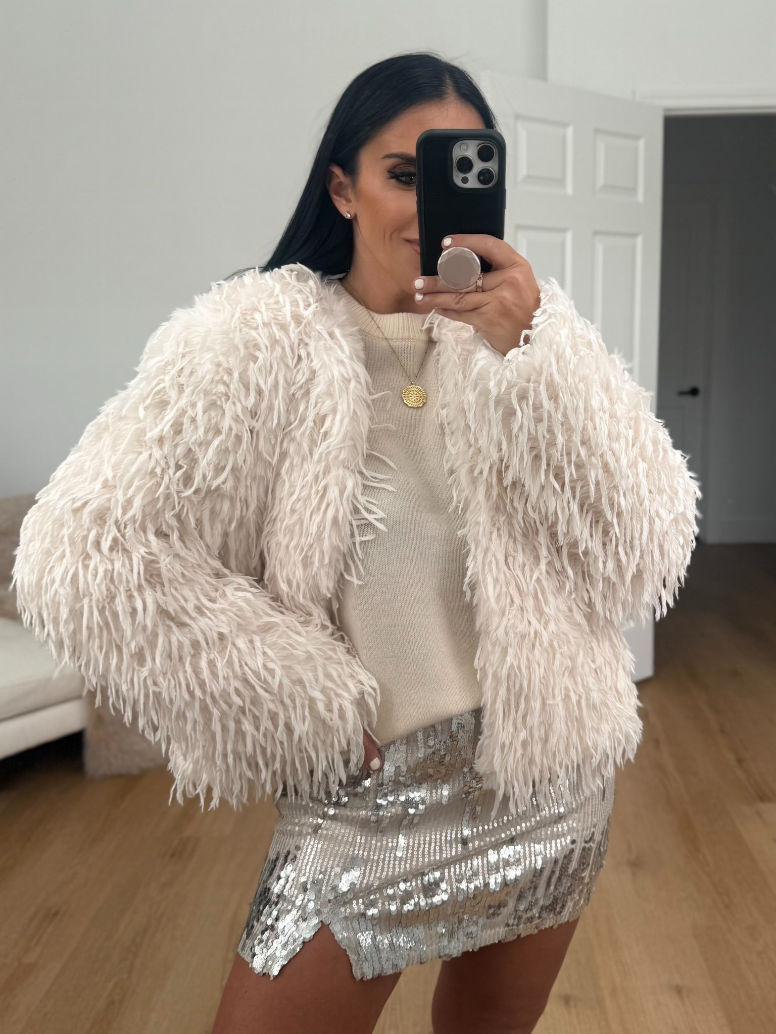 Madden NYC Women's Sequin Mini Skirt wearing size small. Women's Whispy Faux Fur Jacket wearing size small. Cashmere crewneck sweater.
