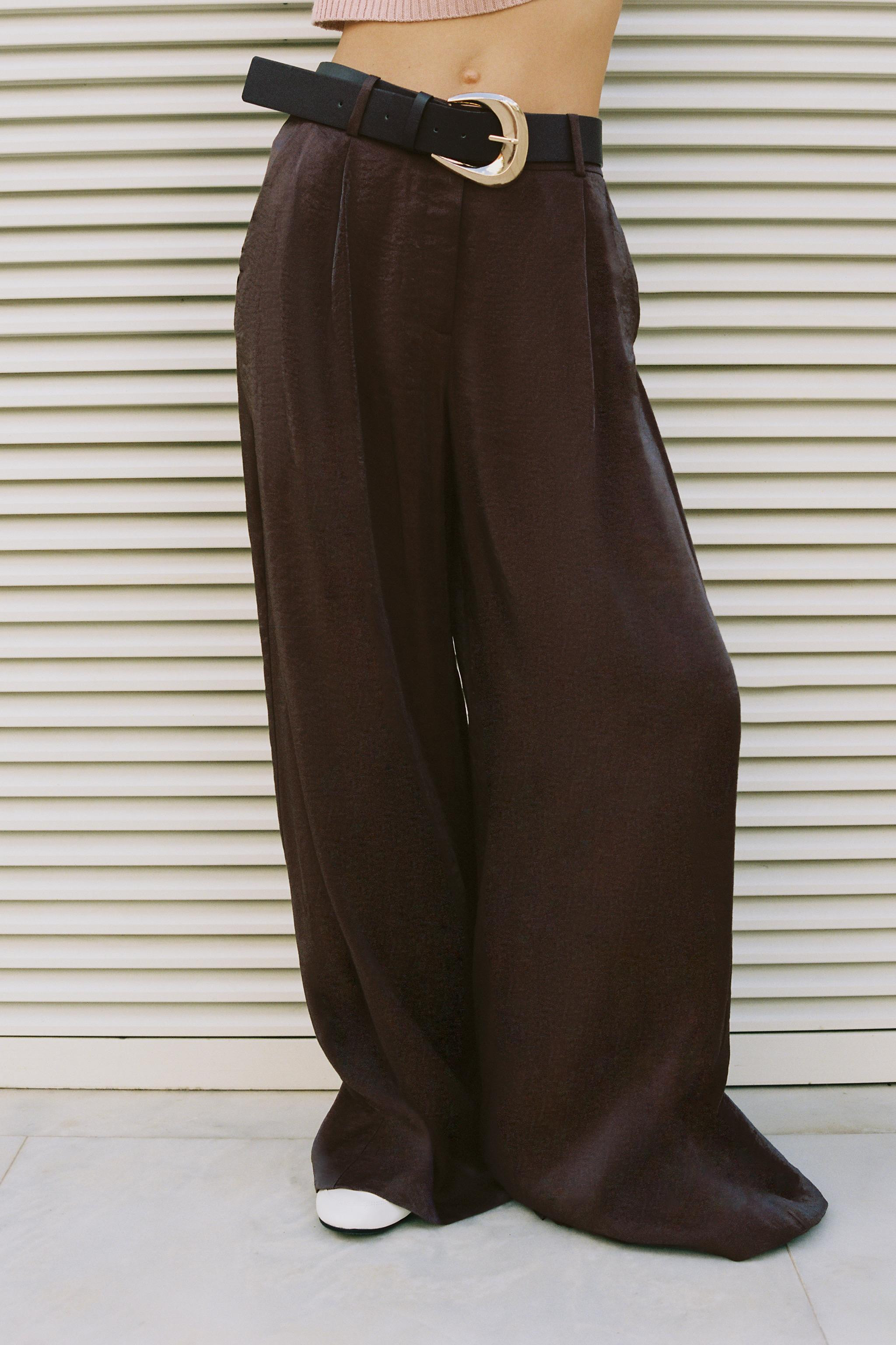 High-waisted satin trousers with front pleats. Front pockets. Belt detail. Wide leg. Front zip, i... | Zara US