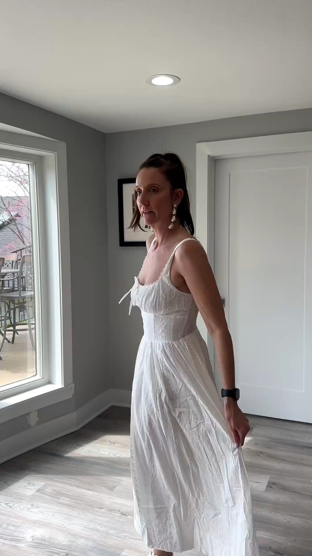 A crisp white sundress is the ultimate canvas for a spring afternoon. ☁️✨ I’m absolutely loving the romantic, smocked bodice on this midi—it’s the perfect blend of feminine and effortless. Tap the link in my bio to shop this exact look and see how I’m styling my favorite seasonal dresses! #WhiteSundress #SpringStyle #MidiDress #ShopTheLook

My Coastal Cowgirl Style Breakdown
• The Dress: I’m wearing a white sleeveless midi dress featuring a romantic sweetheart neckline with a tie-front detail and a structured, smocked waistline.
• The Fabric: The dress is crafted from a delicate eyelet or dotted swiss cotton that adds a beautiful, airy texture to the voluminous skirt.
• The Footwear: I paired the feminine dress with tan suede pointed-toe boots to add a touch of "coastal cowgirl" edge to the look.
• The Accessories: I’ve styled the ensemble with a tan leather crossbody bag and my signature tiered pearl earrings to maintain a polished, organized energy.
• The Hair: I’ve pulled my hair back into a sleek, high ponytail to let the delicate neckline and bodice details take center stage.

white sundress, eyelet midi dress, smocked waist dress, tan western boots, pointed toe boots, tan boots Louis button#LTKFestival

#LTKmomlife #LTKootd #LTKOver40