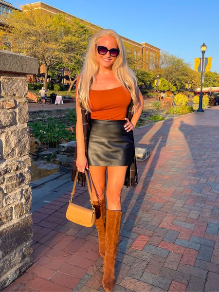 A cute fall outfit for a hot October day. Loving this faux leather mini skirt and the mix of rust and black in this outfit! Also linked some cute brown knee high boots. 

#LTKSeasonal #LTKover40 #LTKstyletip