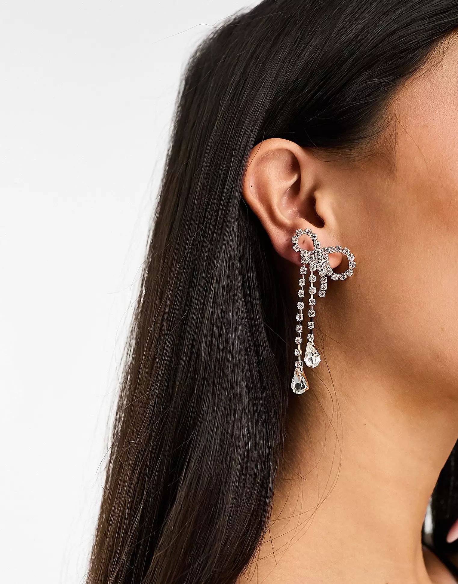 True Decadence bow waterfall earrings with crystal drop in silver and gold | ASOS (Global)