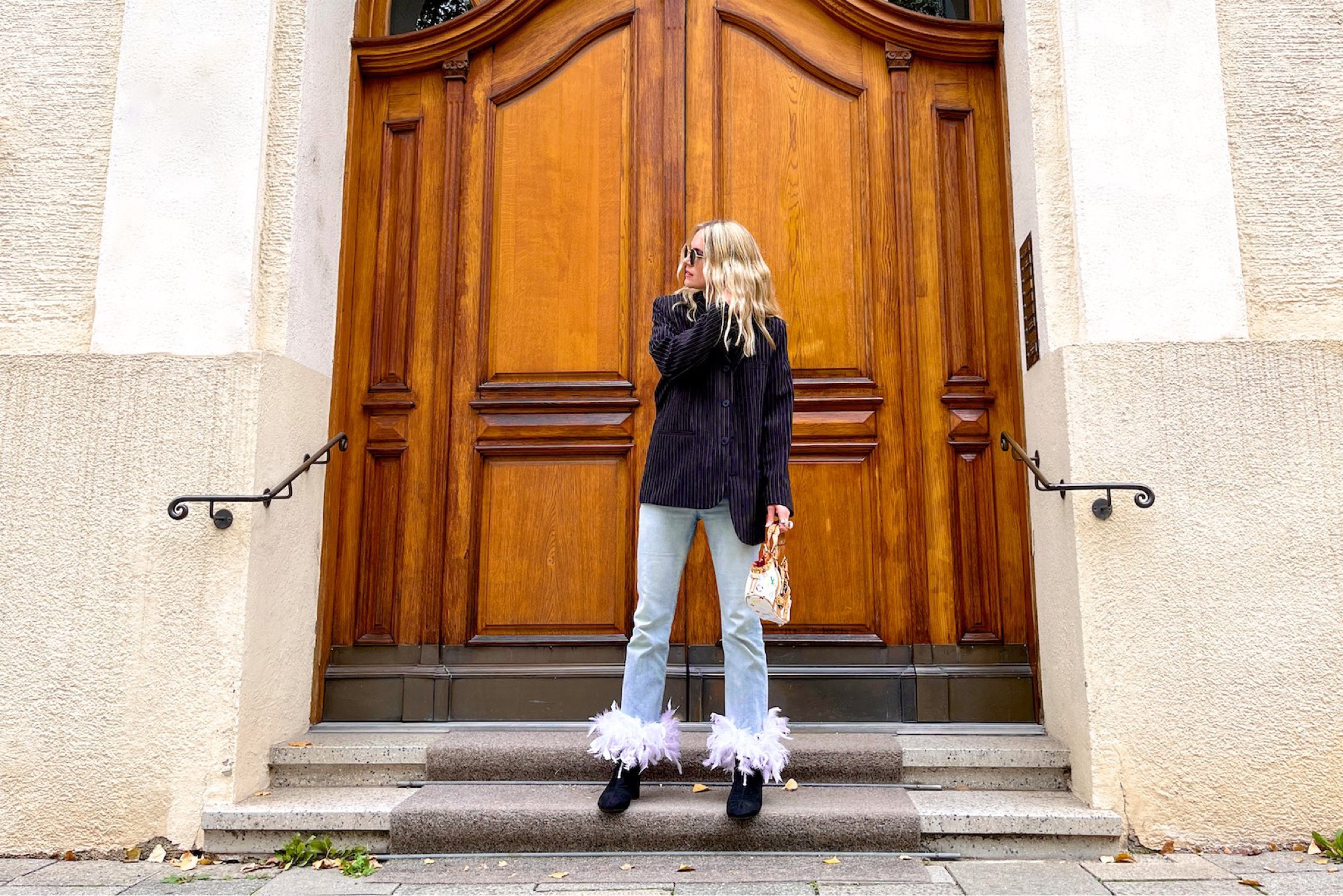 Feather Hem Jeans. Fashion Blogger Girl by Style Blog Heartfelt Hunt. Girl with blond hair wearing feather hem jeans, pinstriped blazer, white tee, Ray-Ban sunglasses, Louis Vuitton bag and sock boots. #colorfuloutfit #colorfulstyle #colorfulfashion #colorfullooks #fashionfun #cutefalloutfit #fallfashion2022 #falllookbook #fitcheck #dailylooks #dailylookbook #contentcreator #microinfluencer #discoverunder20k