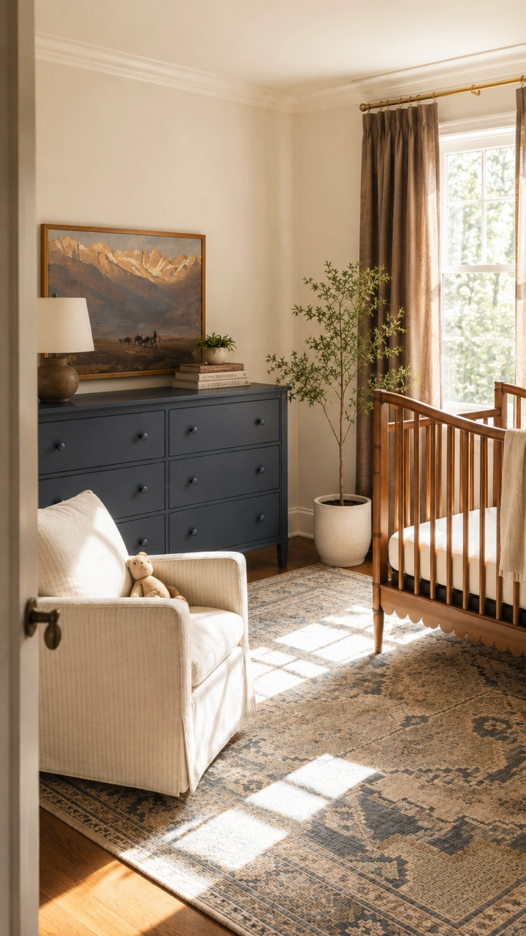 Collected cottage nursery featuring warm oak nursery furniture, navy blue nursery dresser styling, creamy neutral nursery seating, layered vintage inspired rugs, cozy traditional decor, warm natural light, and soft earthy nursery tones. This heritage inspired nursery blends timeless baby room furniture, classic cottage interiors, warm wood accents, neutral nursery decor, heirloom style details, and cozy collected textures for a nursery that feels elevated yet welcoming. Perfect for traditional nursery inspiration, cozy cottage nursery ideas, gender neutral nursery decor, warm neutral baby room styling, collected home aesthetics, and timeless family home interiors. 

 #LTKHome #LTKBaby #LTKKids