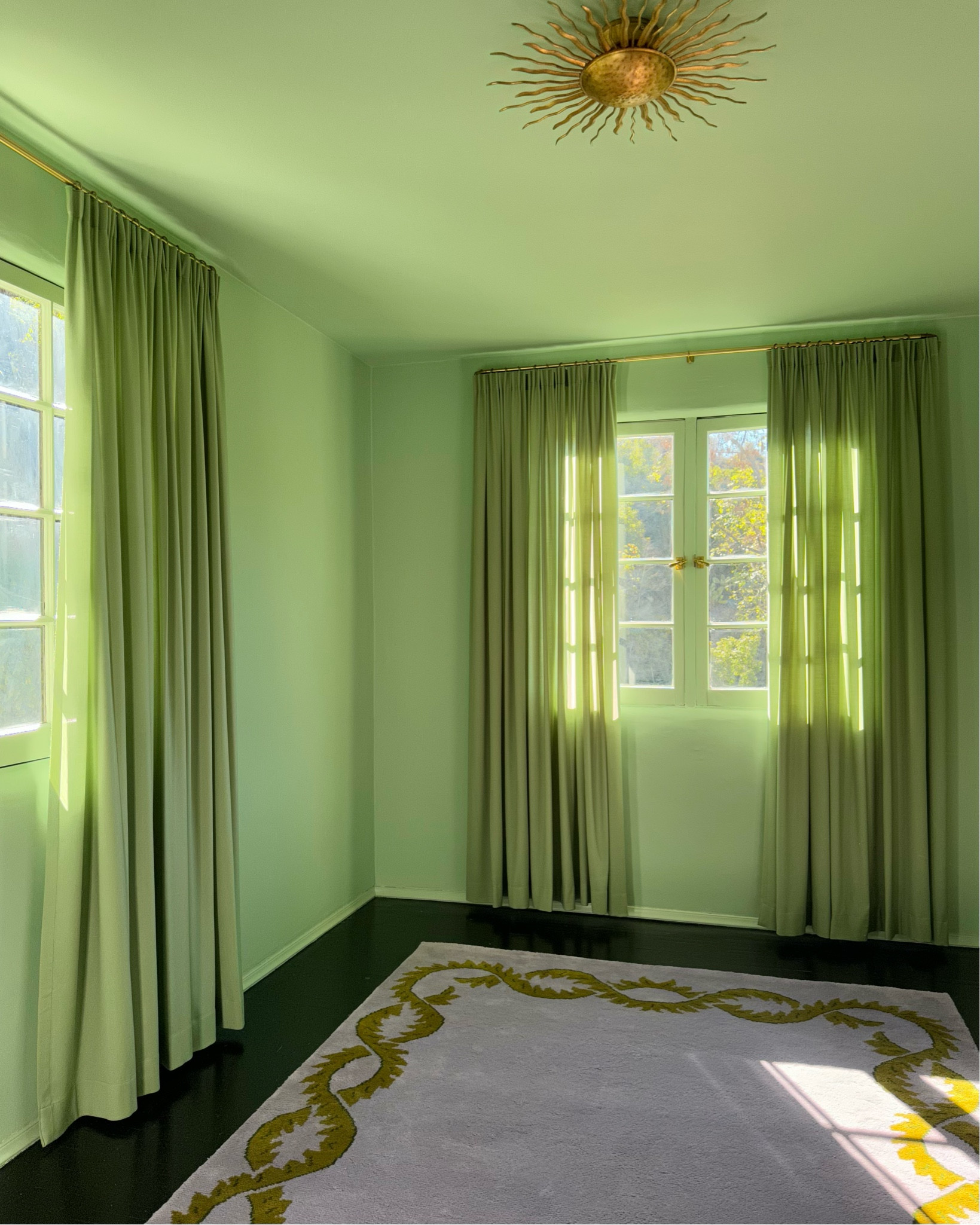 Talk about a transformation! We color drenched our entire guest room in green (Palm by Farrow and Ball) and found the perfect shade of sage curtains from Nordic Knots. Paired with a lilac rug and a sunburst light fixture, our vision to make the room feel like a “gardener’s apartment” is fully coming into focus 💚 

#LTKHome