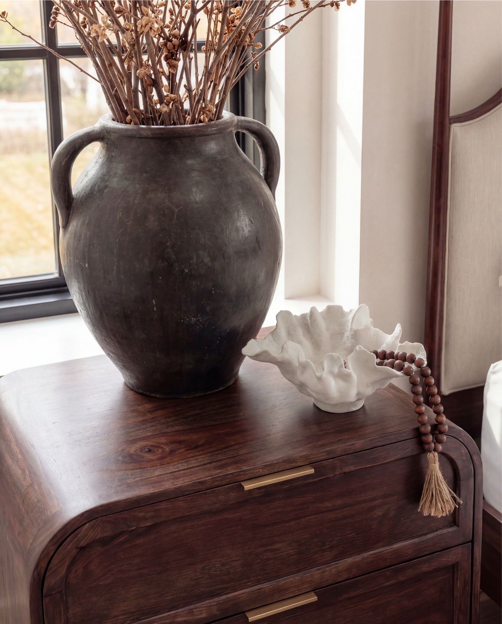 Shop the Look: Bedroom Refresh
Furniture & Decor
	•	Upholstered wood bed frame (cream fabric)
	•	White bedding set
	•	Chunky knit throw (camel)
	•	Patterned accent pillows (rust/brown)
	•	Wood nightstands
	•	Ceramic table lamps (black base, white shade)
	•	Curved brass-framed wall mirror
	•	Framed floral wall art above bed
	•	Upholstered boucle bench stools (set of two)
	•	Vintage-style area rug (neutral pattern)
	•	Wood dresser with brass corner details
	•	Decorative ceramic vase
	•	Stacked neutral books
	•	Brass decorative tray
	•	Sculptural brass object
	•	Framed artwork above dresser
	•	Exposed wood ceiling beams

#LTKSaleAlert #LTKHome