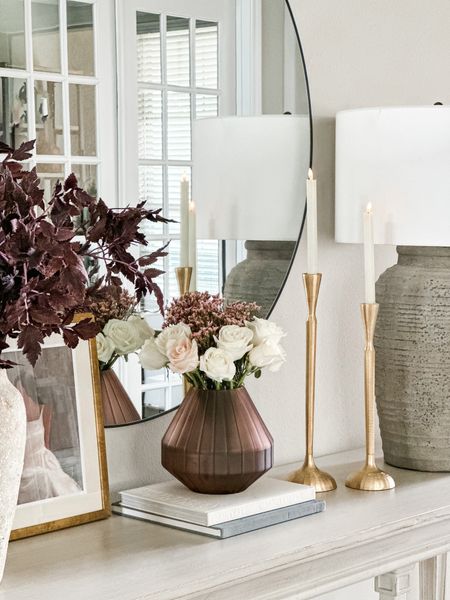A view into my entryway console table!! The beautiful glass vase that’s perfect for spring and Valentine’s Day, my Pottery Barn lamp, the beautiful gold taper candle holders, the target art and my oversized round mirror are all
Linked here! 

#LTKSeasonal #LTKhome #LTKstyletip