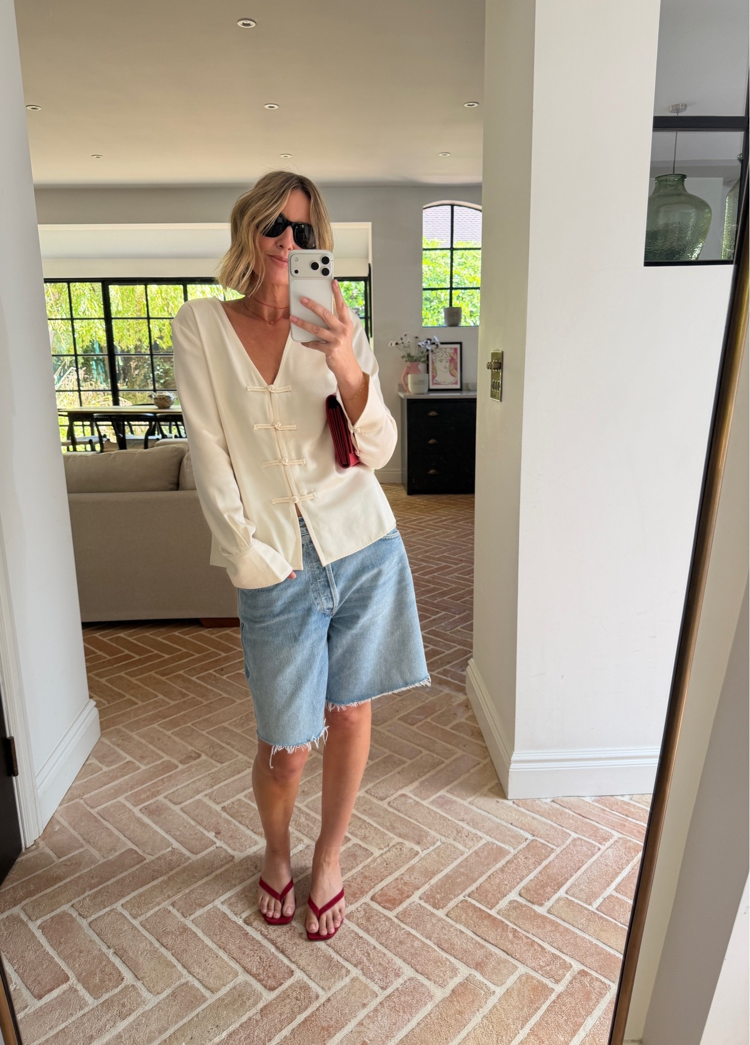 ivory satin blouse, frog closure top, cheongsam style blouse, v neck satin top, denim bermuda shorts, frayed hem denim shorts, distressed jean shorts, red flip flops, thong sandals, red clutch bag, layered necklace, black sunglasses, elevated casual outfit, mixed dressy and casual, summer transitional style, quiet luxury, elevated basics, effortless summer style, ltkstyletip, ltkseasonal, ltksummer, ltkfindsunder100, outfit inspo, capsule wardrobe essentials

#LTKsummer #LTKdatenight #LTKeurope