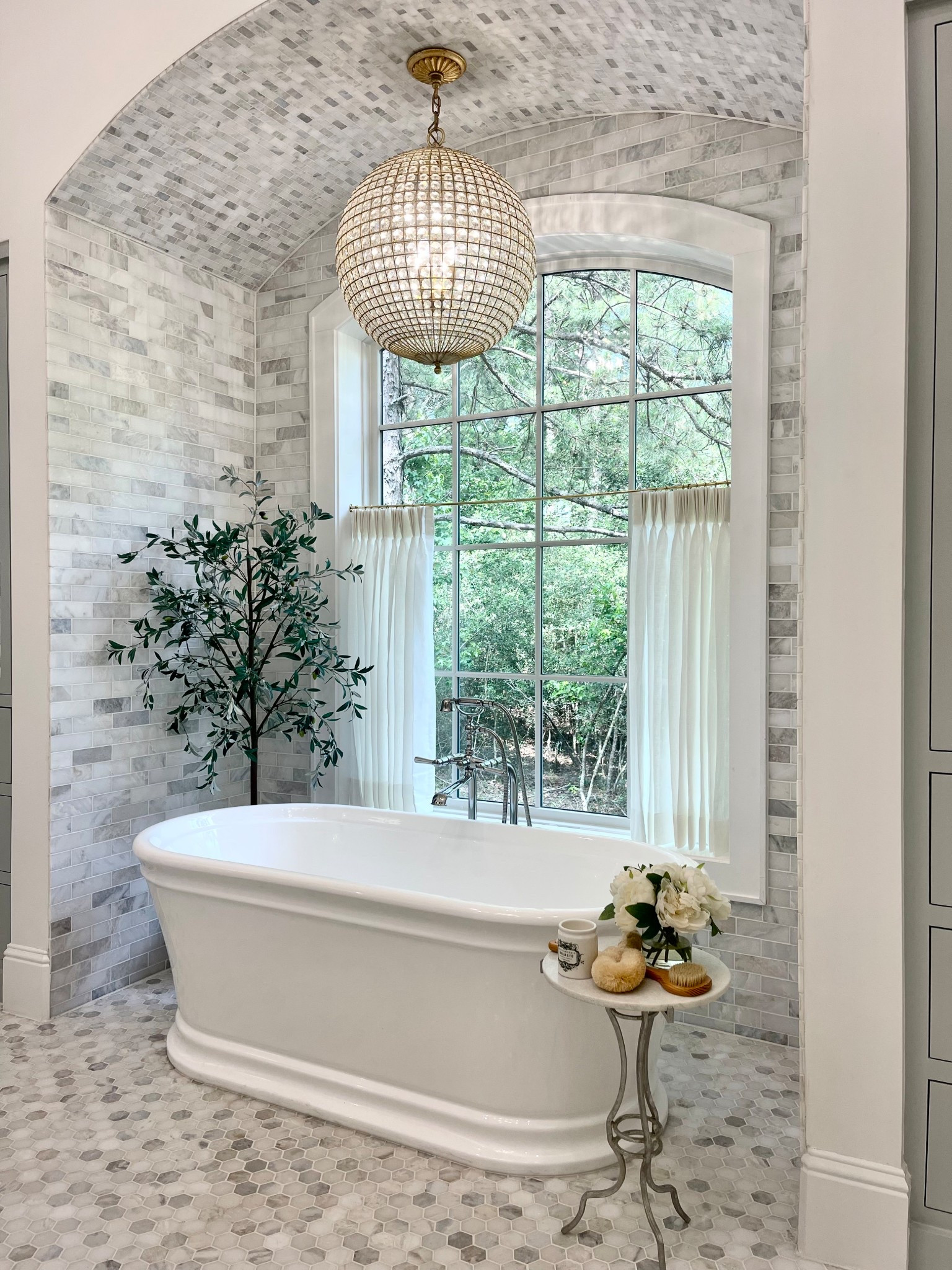 Bathroom fixtures and decor 
Chandelier, free standing faucet, bathtub, olive tree, planter

#LTKHome