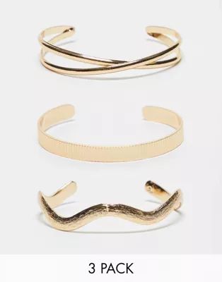 ASOS DESIGN 3-pack cuff bracelets with mixed designs in gold tone | ASOS (Global)