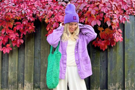 Very Peri. Fashion Blogger Girl by Style Blog Heartfelt Hunt. Girl with blond hair wearing a very peri colored denim shacket, purple beanie, beige sweater, wide leg pants, green straw bag and New Balance sneakers. #colorfuloutfit #colorfulstyle #colorfulfashion #colorfullooks #fashionfun #cutefalloutfit #fallfashion2022 #falllookbook #fitcheck #dailylooks #dailylookbook