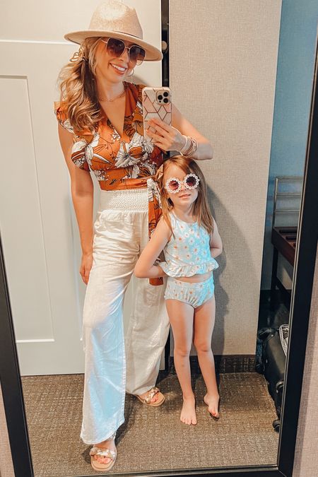 Boho tropical vacation vibes! Brynn’s daisy swimsuit is in 5/6. Love the ruffles and simplicity of it! So cute!

These are my favorite white swim cover up pants! They are from Belk! Target has a similar pant and it is linked! This top is from a romper set, also linked! 

#LTKkids #LTKSeasonal #LTKfamily