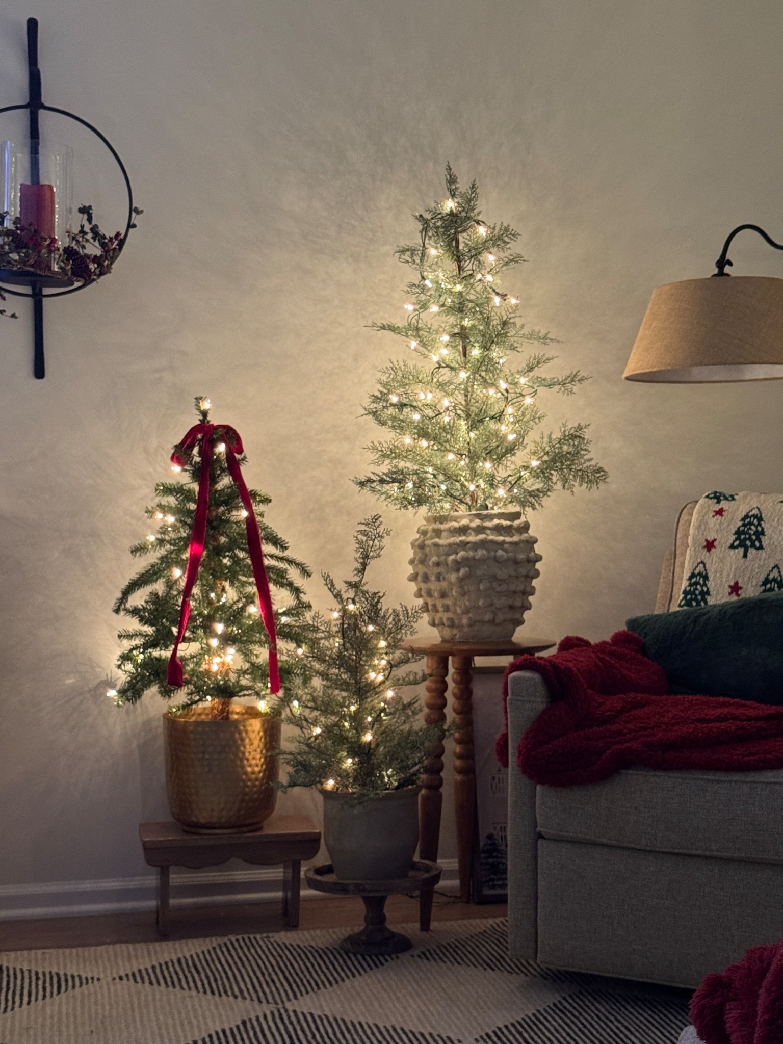 Pretty candle sconce and candle ring wreath, Swivel rocker, red throw, solid wood accent table, Christmas trees, 2” wide soft red ribbon, cream knot vase similar to mine, similar floor lamp at a great price point.

#LTKHome #LTKHoliday