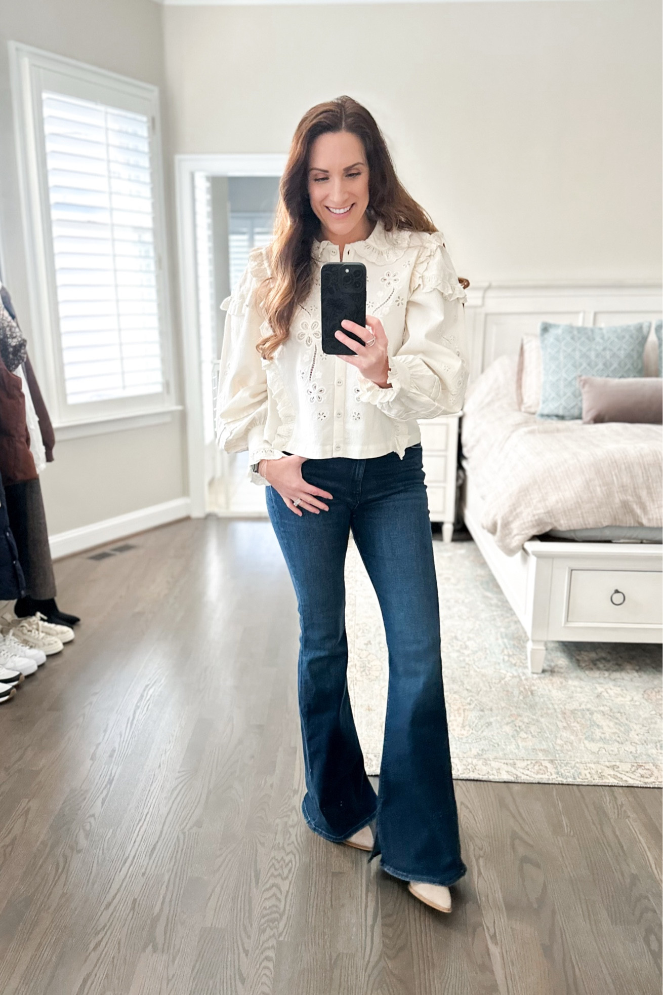 An ultra-feminine eyelet top for seasonal dinners, the Adelie white blouse is embroidered with beautiful floral eyelet motifs and beading. Cut to a flowy silhouette, this ruffled top spotlights an eyelet trimmed Peter Pan collar, long billowy sleeves, and eyelet ruffle trims throughout the bodice. 🖤

#LTKOver40 #LTKStyleTip #LTKSeasonal