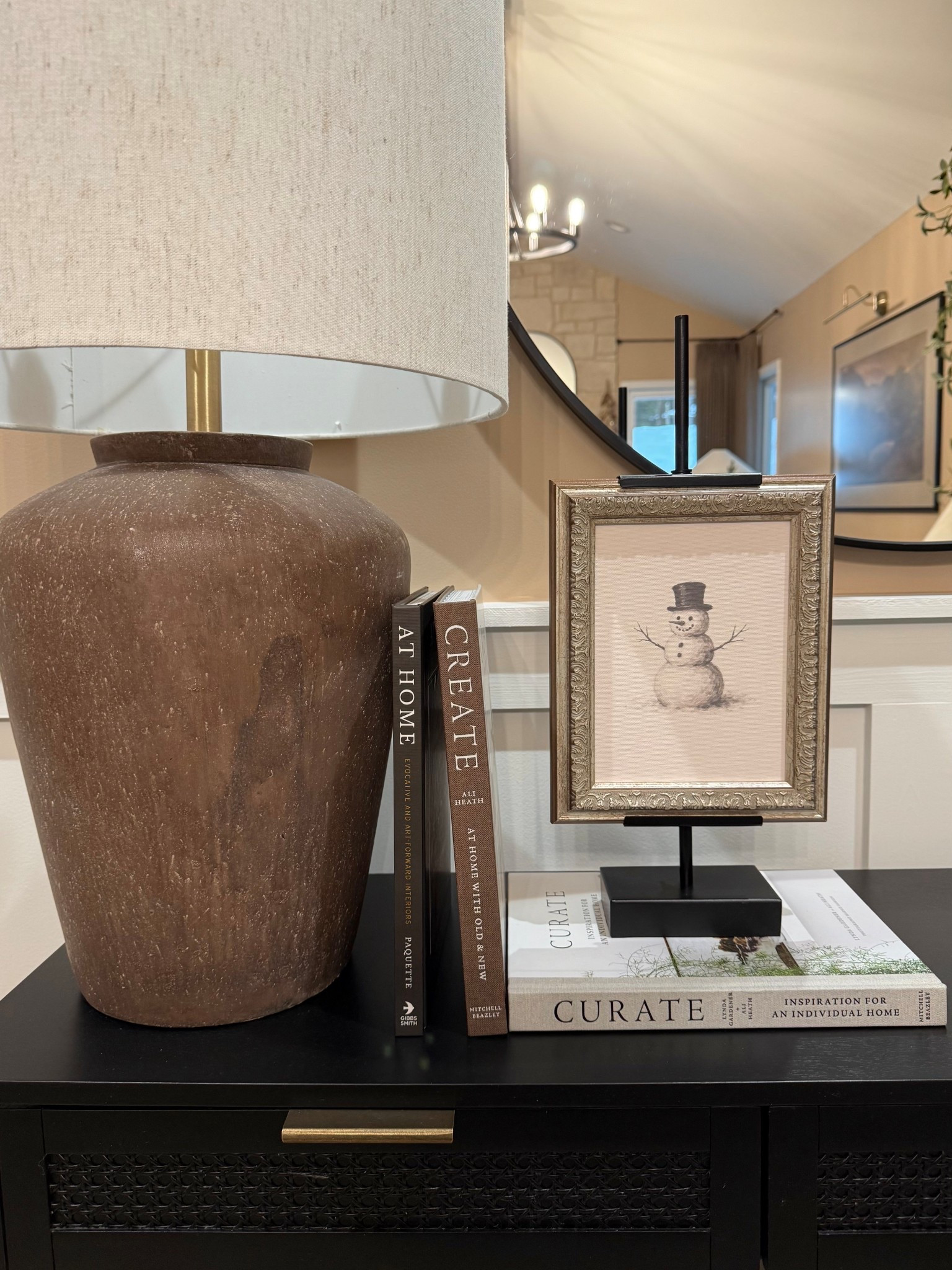 Cozy Winter Console Table Decor With Warm Neutrals

Follow @farmtotablecreations on Instagram for daily home finds, styling ideas, and cozy seasonal inspiration.

This winter console moment is all about layering warm neutrals, soft textures, and simple seasonal accents. A ceramic lamp adds warmth and height, while stacked neutral books create an easy foundation for styling. The framed snowman artwork brings in a subtle winter touch without feeling overly seasonal, making it perfect to leave up through the colder months. I love mixing darker wood tones, soft whites, and black accents to keep everything grounded and timeless. A simple setup like this makes an entryway or hallway feel welcoming, cozy, and thoughtfully styled for winter.

#consoledecor #winterdecor #cozyhome #neutralhome #warmneutrals #modernorganic #entrywaydecor #entrywayinspo #consoleinspo #homeinspo #homeinspiration #seasonaldecor #winterrefresh #neutraldecor #layereddecor #ceramiclamp #framedart #winterart #booksdecor #consoletable #homefinds #decorfinds #ltkhome #ltkfinds #shopmyhome #affordabledecor #timelessdecor #classicstyle

#LTKSaleAlert #LTKHome #LTKFindsUnder50