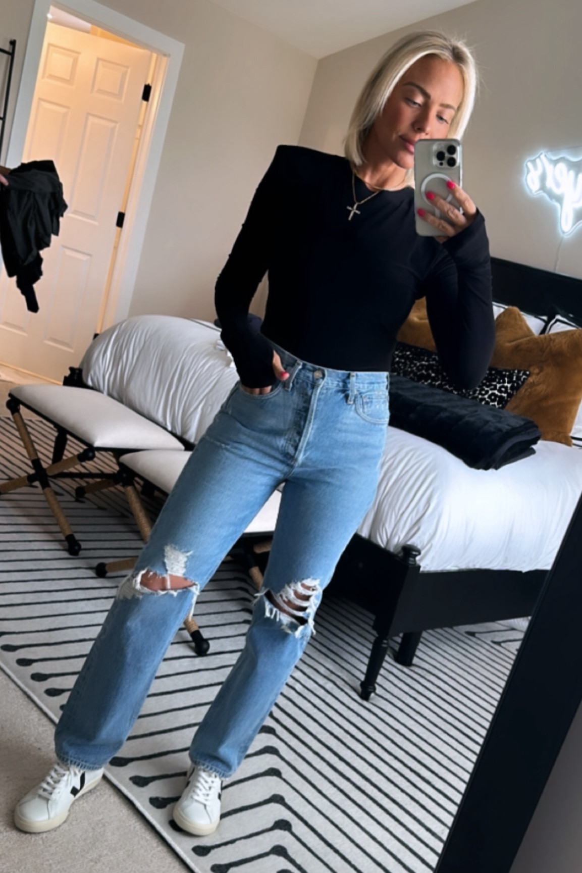 I promise once you figure out these jeans they are THE cats pa…jeans 😉👖 I’m typically a size 27 and you MUST size down TWO sizes (I wear a 25) if you want these to be a little more fitted. Size down ONE size if you want them to be a looser fit (then I would be a 26). I love the fit of the 25’s on me! They’re a perfect high rise and I promise the quality is worth every penny 💵 
THIS TOP IS PURE GOLD 💰 NOT overpriced, FEELS LIKE BUTTER 🧈 ,has perfect shoulder pads to accentuate your waist. Also NOT a bodysuit (thank God it’s so much easier to pee without them 😂) but has enough length to tuck in. Also has the thumb holes I love, but you don’t notice them if you don’t want to use them. Throw on a cute necklace and a good pair of Veja’s and you have the perfect chic Saturday ‘fit! ☀️

#LTKstyletip #LTKSeasonal #LTKworkwear