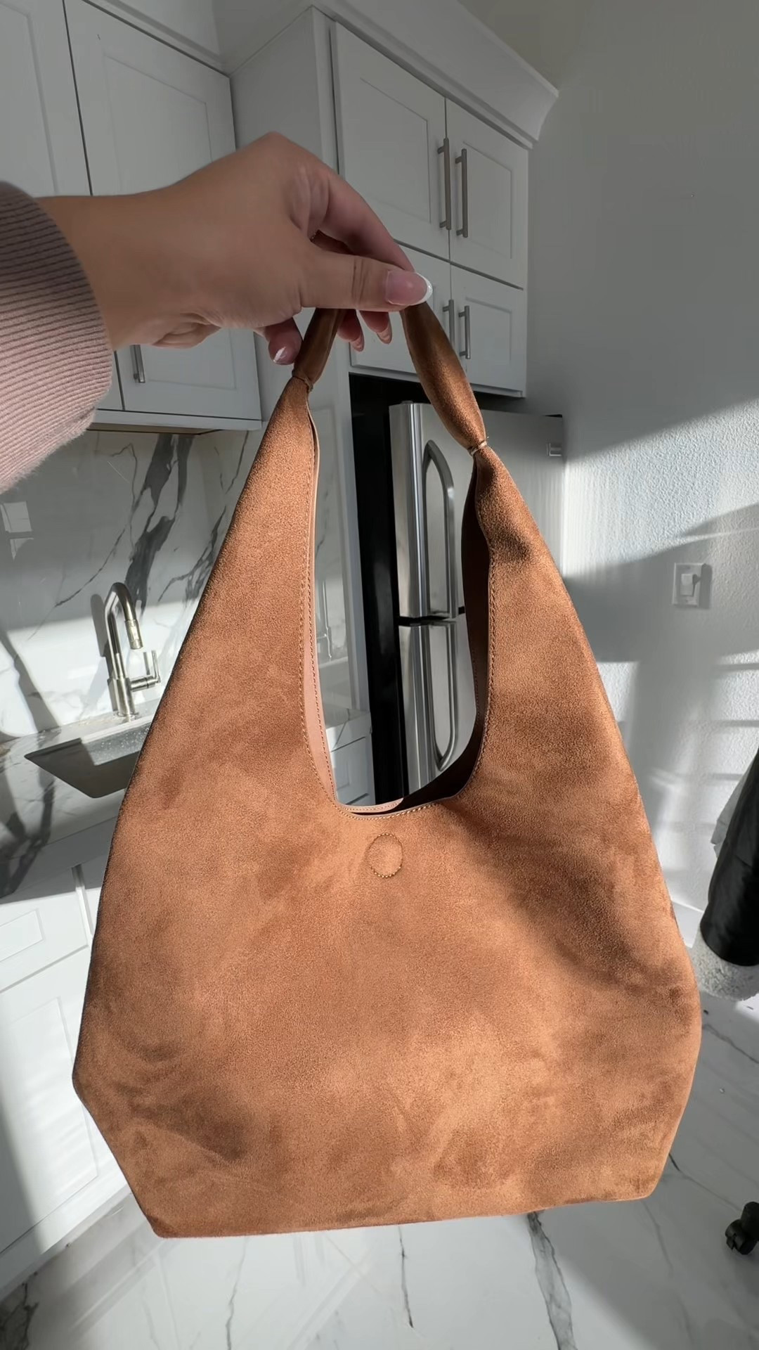 Fall closet essential: this brown suede bag is giving cozy luxe vibes all season long! #handbag #fall #fallaccessories #bag 

#LTKItBag #LTKStyleTip #LTKSaleAlert