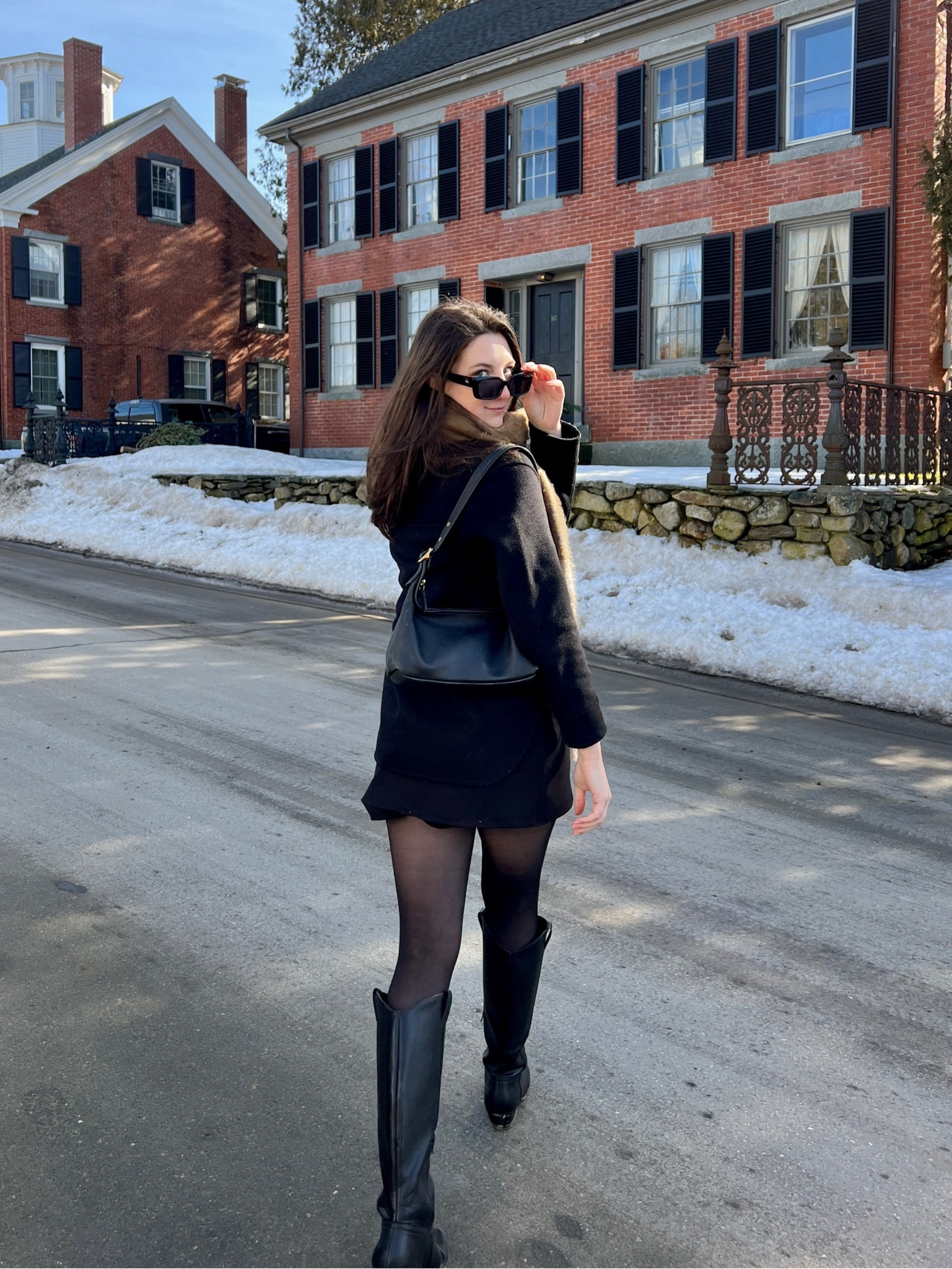 Warm winter outfit with pattered brown scarf, black wool jacket, black skirt, tights, and black boots 

#LTKSeasonal
