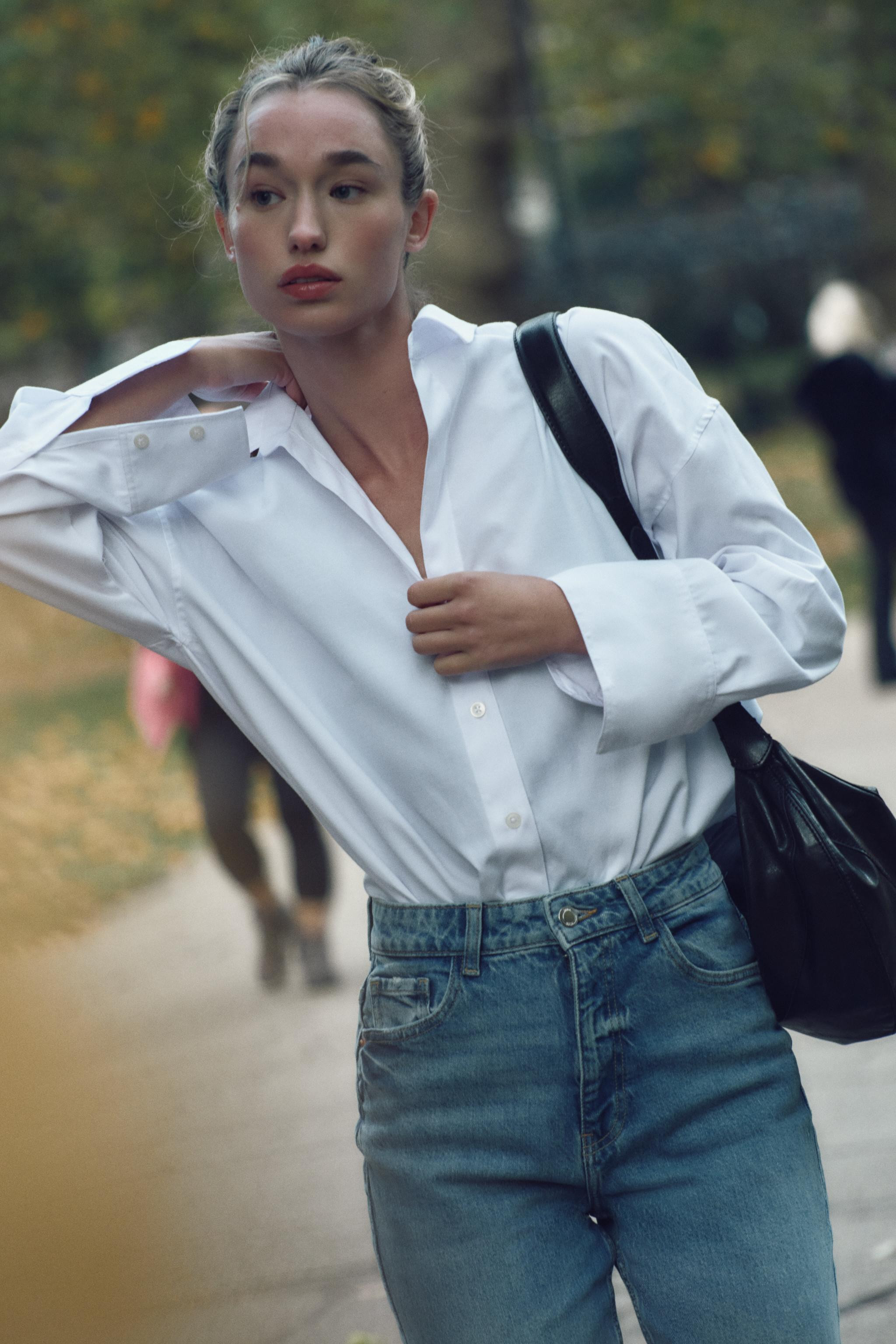 Shirt made with cotton blend fabric. Lapel collar with V-neck and long sleeves. Asymmetric hem. F... | Zara US