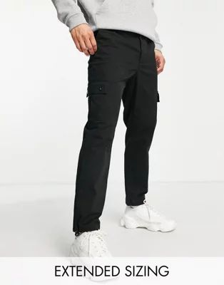 ASOS DESIGN tapered cargo pants in black with toggles | ASOS (Global)