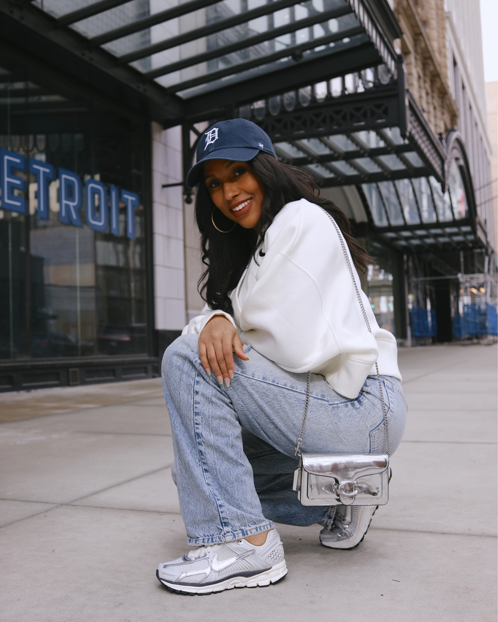 Nike set. Nike women. Nike shoes. Coach purse.  Baseball cap. Casual outfit.  Mom jeans  