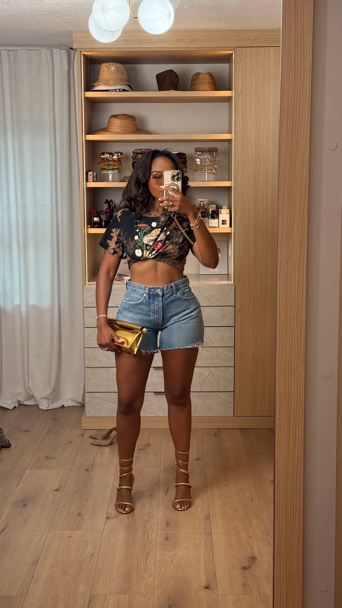 Hi Babes! 🖤✨

An oversized graphic tee and denim shorts will never go out of style! I gave this casual look a little edge by knotting the tee and pairing it with strappy heels and a metallic clutch. It's the perfect mix of effortless and elevated.

✨ Fit Details:
• Wearing a size Small
• Oversized vintage graphic tee (styled knotted)
• High-rise distressed denim shorts
• Gold strappy heels
• Metallic gold clutch
• Layered gold jewelry to finish the look

🖤 Where to Wear:
• Concerts
• Girls' night out
• Casual date night
• Weekend brunch
• Summer festivals
• Vacation exploring

This is proof that basics don't have to be boring—just switch up the accessories and you've got a whole new vibe!

Everything is linked below!

xx, Kira | IG: KirasFashionFinds

Measurements:
Kira: 5'4" | Size Small | 140 lbs