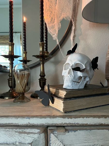 Chic Halloween decor for your entry 💀 Skull, black butterflies, vintage candlesticks, twisted tapers… The gangs all here.



#LTKhome #LTKHalloween
