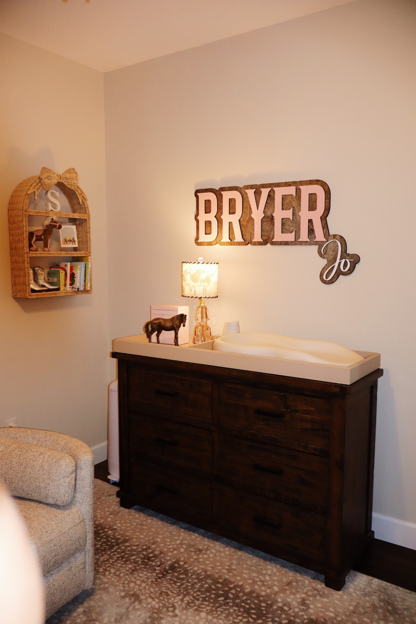 Nursery name sign, wicker shelf, rug, and changing pad 