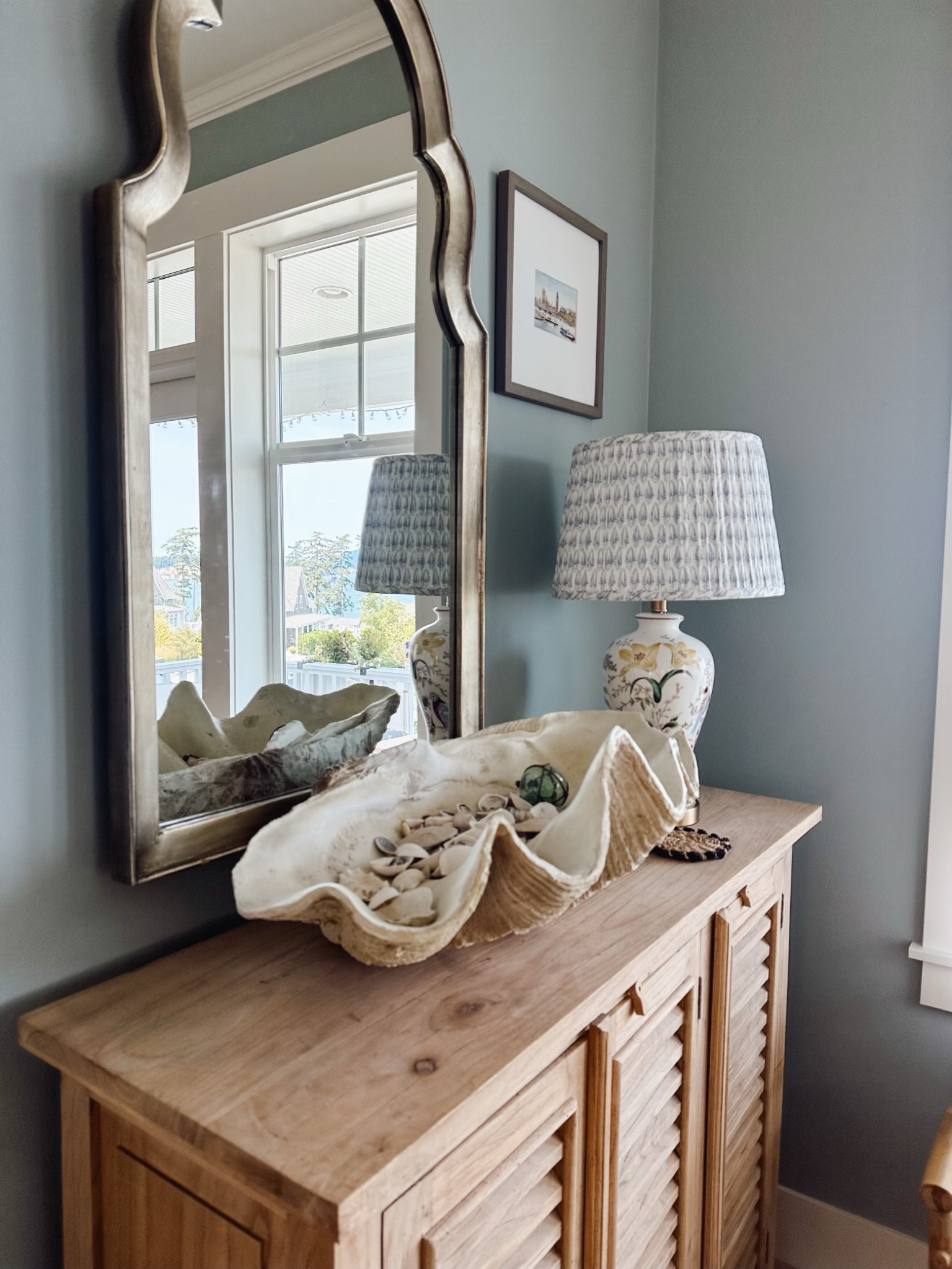 Fossilized clam shell decorative bowl (similar), similar floral lamp, blue and white pleated shade, similar arched mirror 

#LTKhome #LTKstyletip #LTKSeasonal