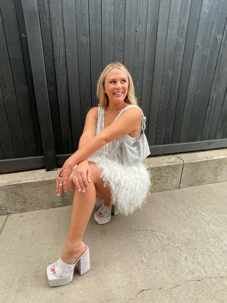 disco theme bachelorette outfit: feather dress with sequins, sparkly platform heels, sparkly purse. dress ran a bit big. heels run .5 size small. 
