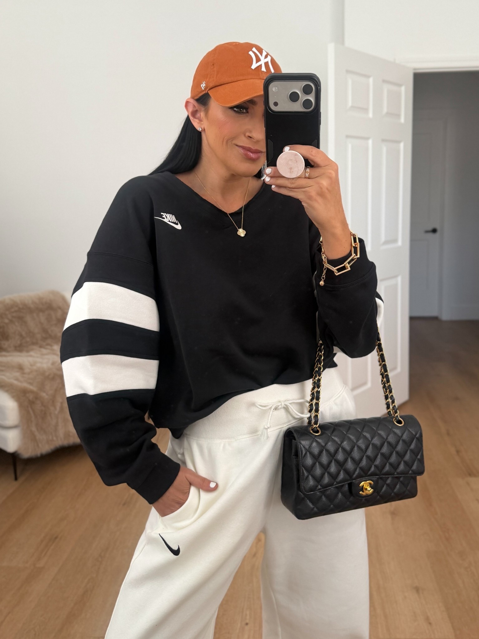 Nike Sportswear Phoenix Fleece Women's High-Waisted Wide-Leg Pants wearing size medium. Nike Sportswear Club Fleece Women's Oversized V-Neck Sweatshirt wearing size small. 
